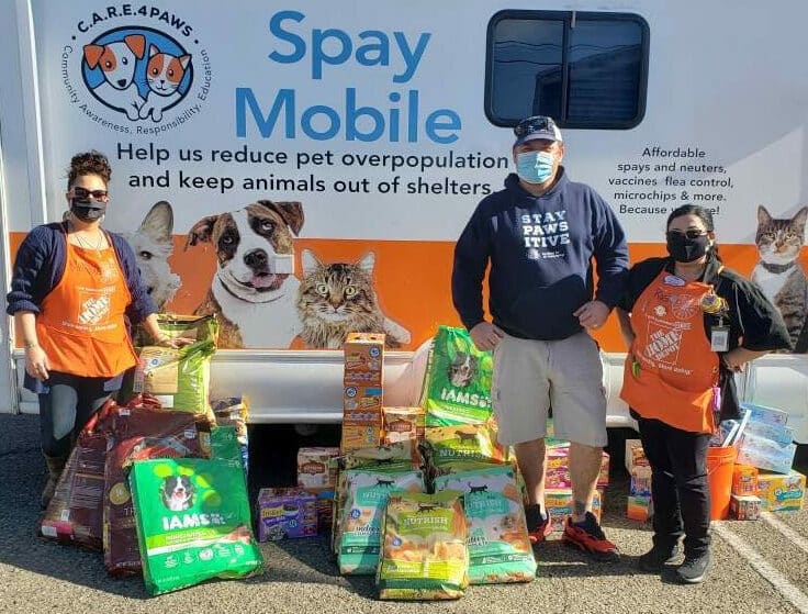 C.A.R.E.4Paws Donation Drive in Santa Barbara at Home Depot, people with pet food donations