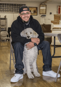 A man and his dog at a C.A.R.E.4Paws Mobile Pet Clinic