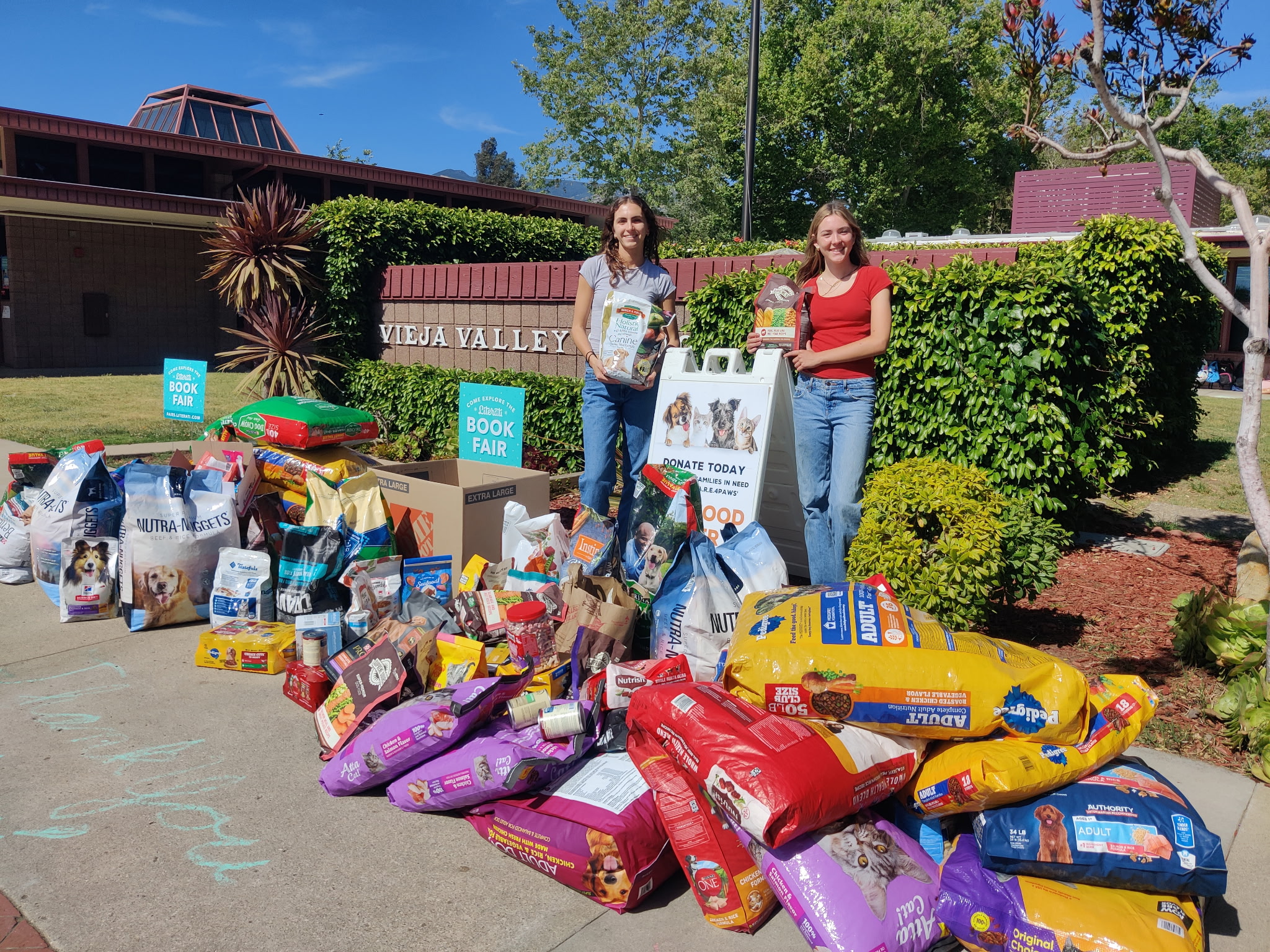 Two students hosting a pet food drive at an elementary school in Santa Barbara
