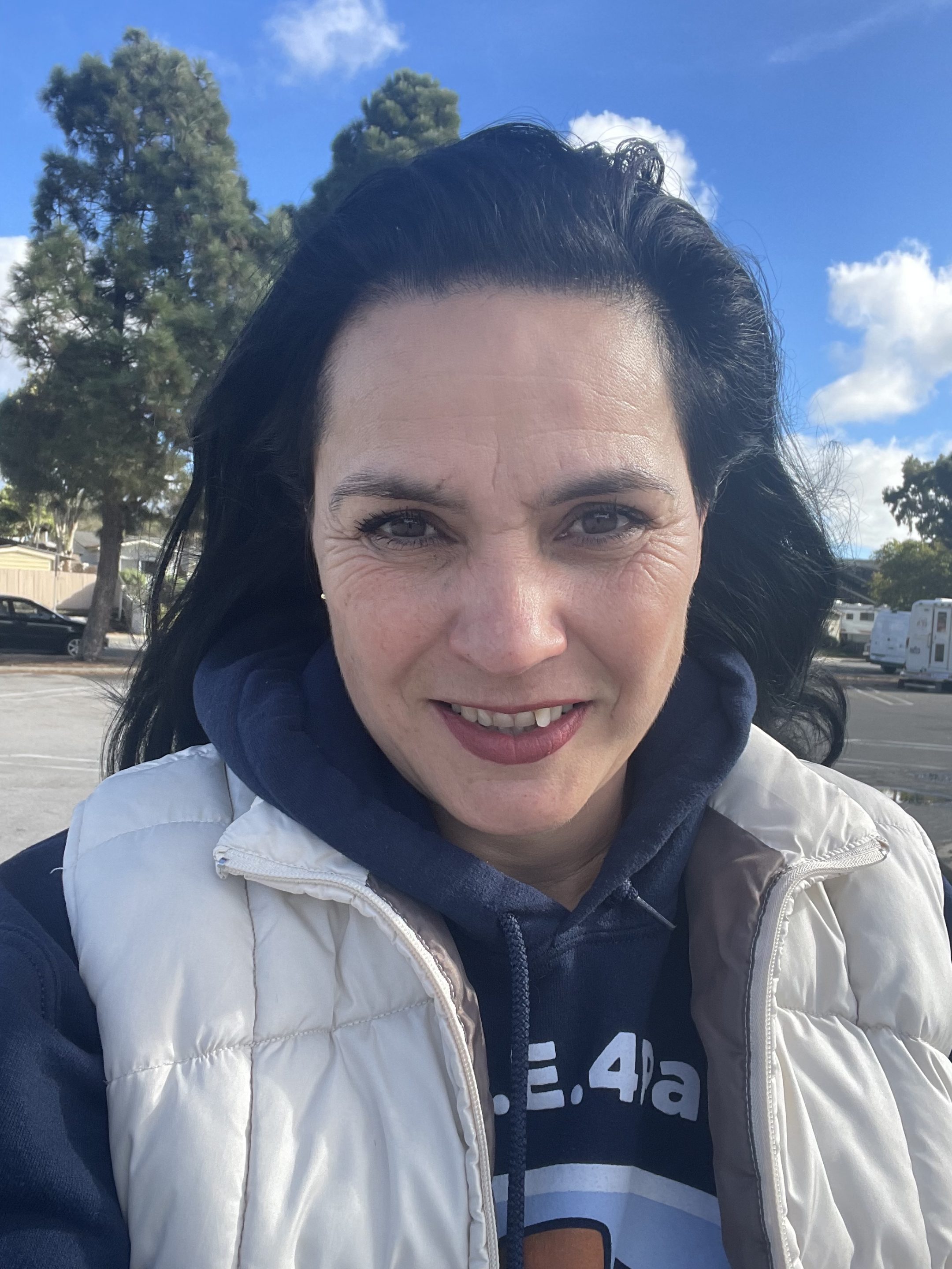 Dr. T with vet tech and orange white kitty inside the mobile vet clinic