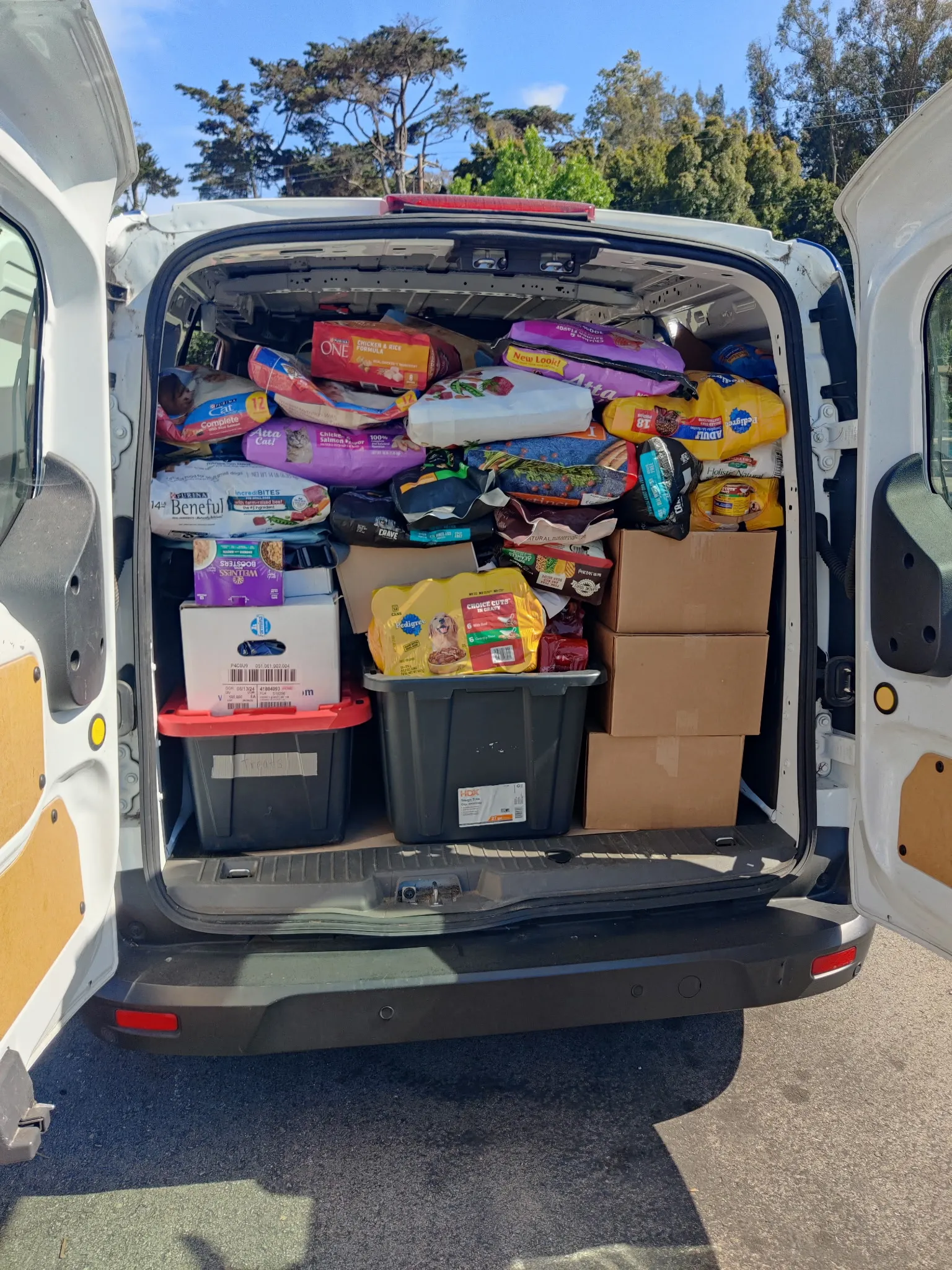 Pet food donations in the news Event Coordinator Erica Valdes with board members Cindy Whelan and Don Connor | Gail Arnold