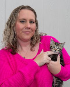 Lady in warm sweater hold a kitten