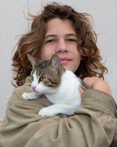 Boy with his white and tabby mixed cat
