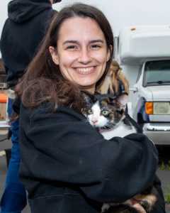 Teen holding cat at mobile pet wellness clinic