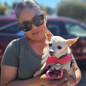 A lady and her small white dog