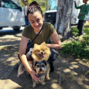 Pet owner with her two small dogs at a pet wellness clinic