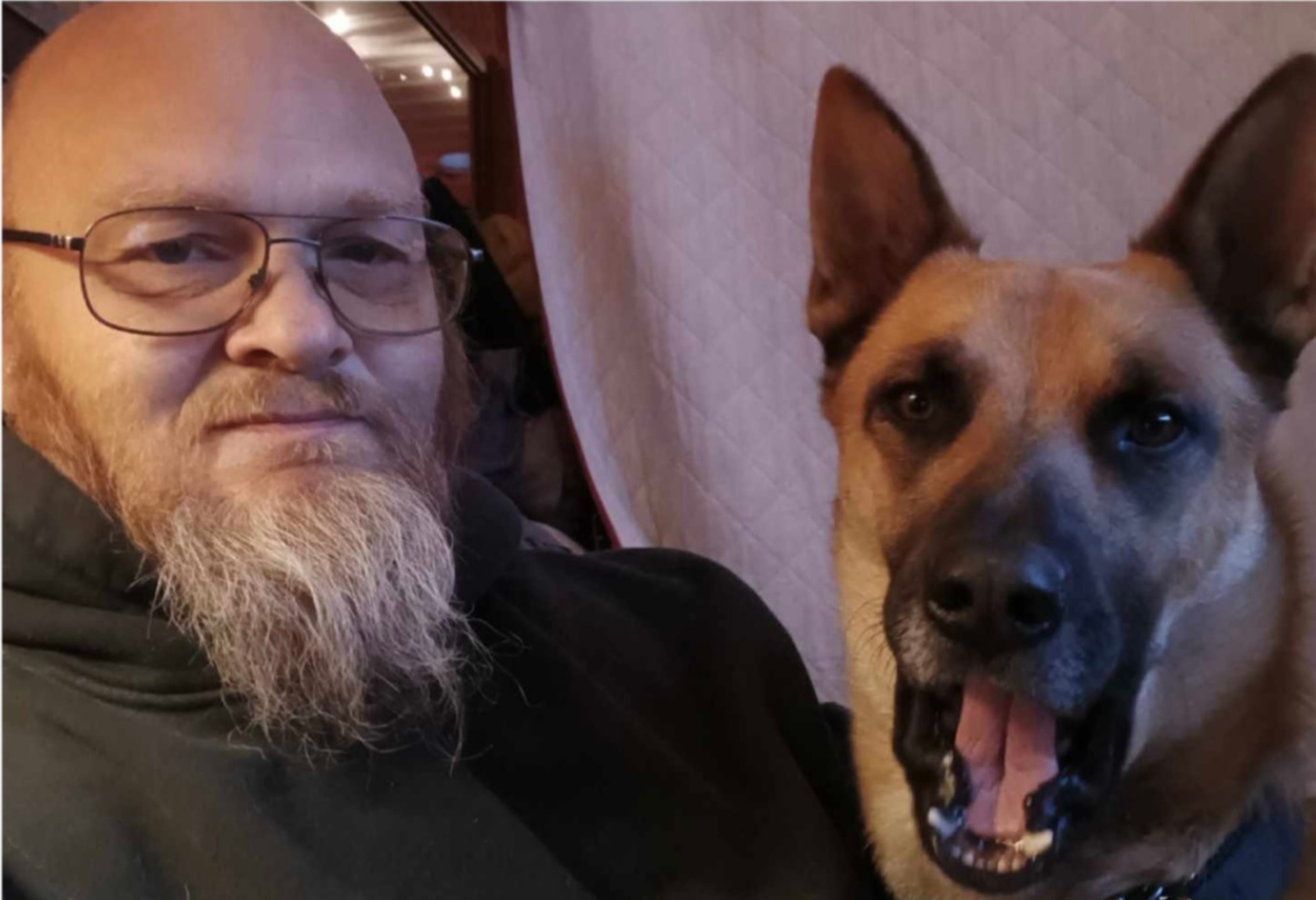 Client smiling with his large dog