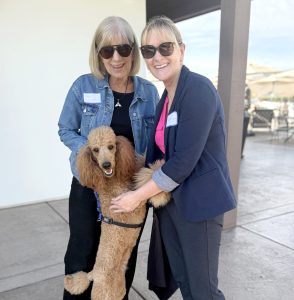Two attendees with their pet