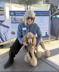 C.A.R.E.4Paws supporter with her curly haired dog at Paws & Pours