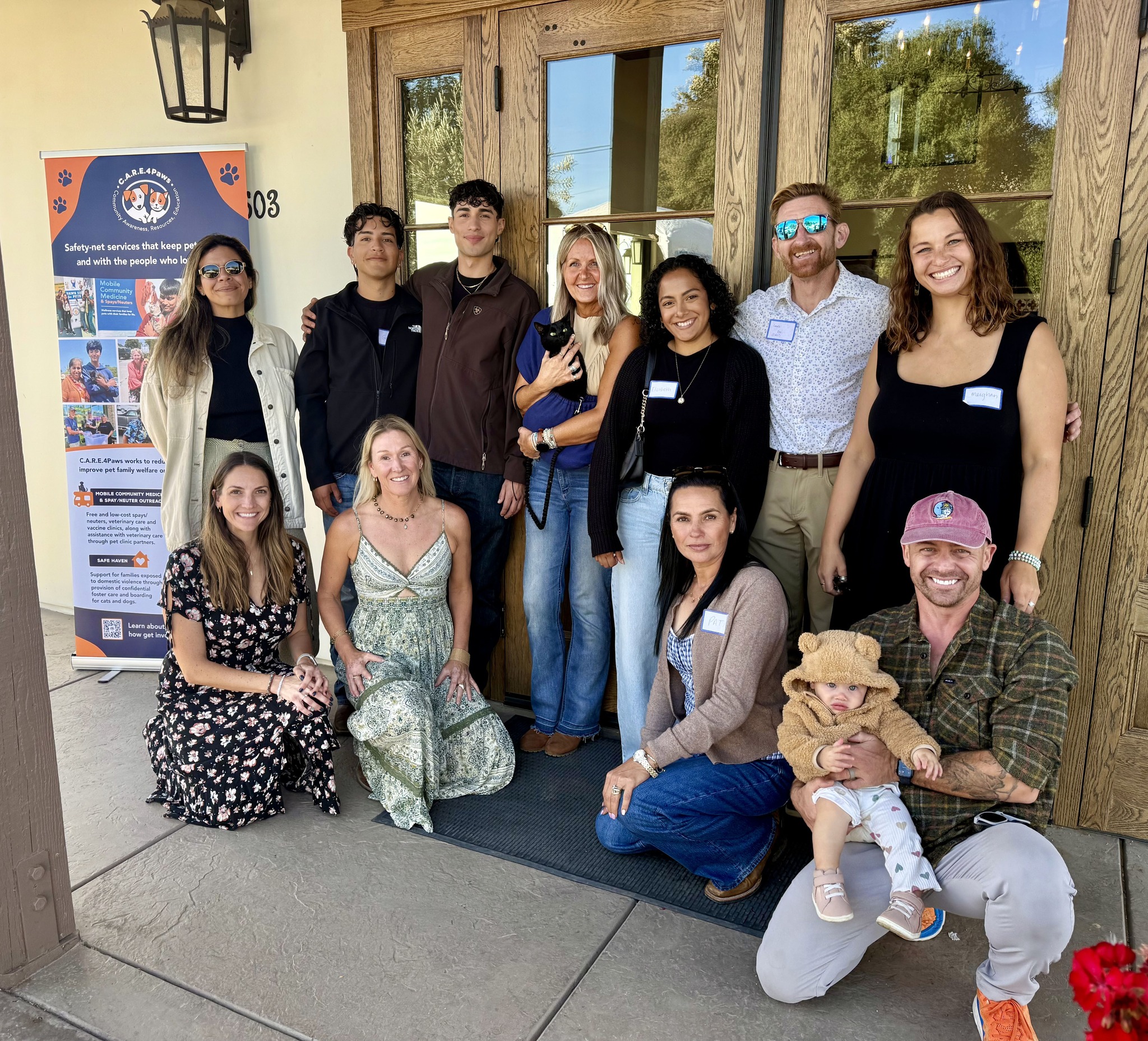Group photo of C.A.R.E.4Paws board members, staff and supporters at the Paws & Pours event