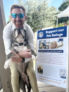 Board member Chris Harris with C.A.R.E.4Paws mascot Lulu the pit bull