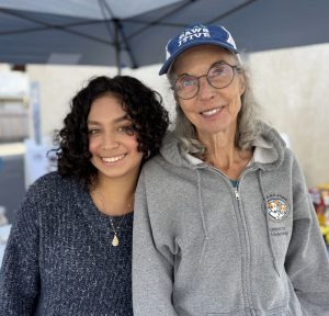 Staff member, Julie Crutcher, and one of the other staff or volunteer at the pet wellness check in tent