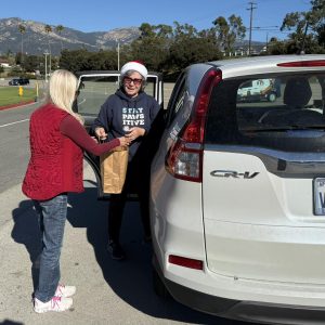 One of our friendly staff members receiving pet food from the drive thru donation drop off line