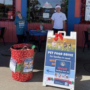 Two C.A.R.E.4Paws volunteers outside our Klondike Pizza donation station