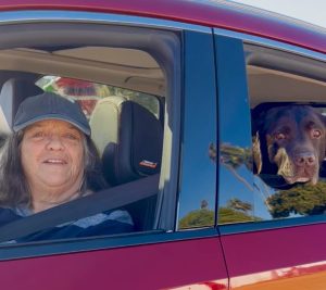 A generous lady and her pup greeting us at our drive-thru donation station