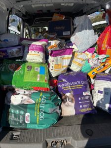 Back of transit van filled with pet food donation for those less fortunate than us