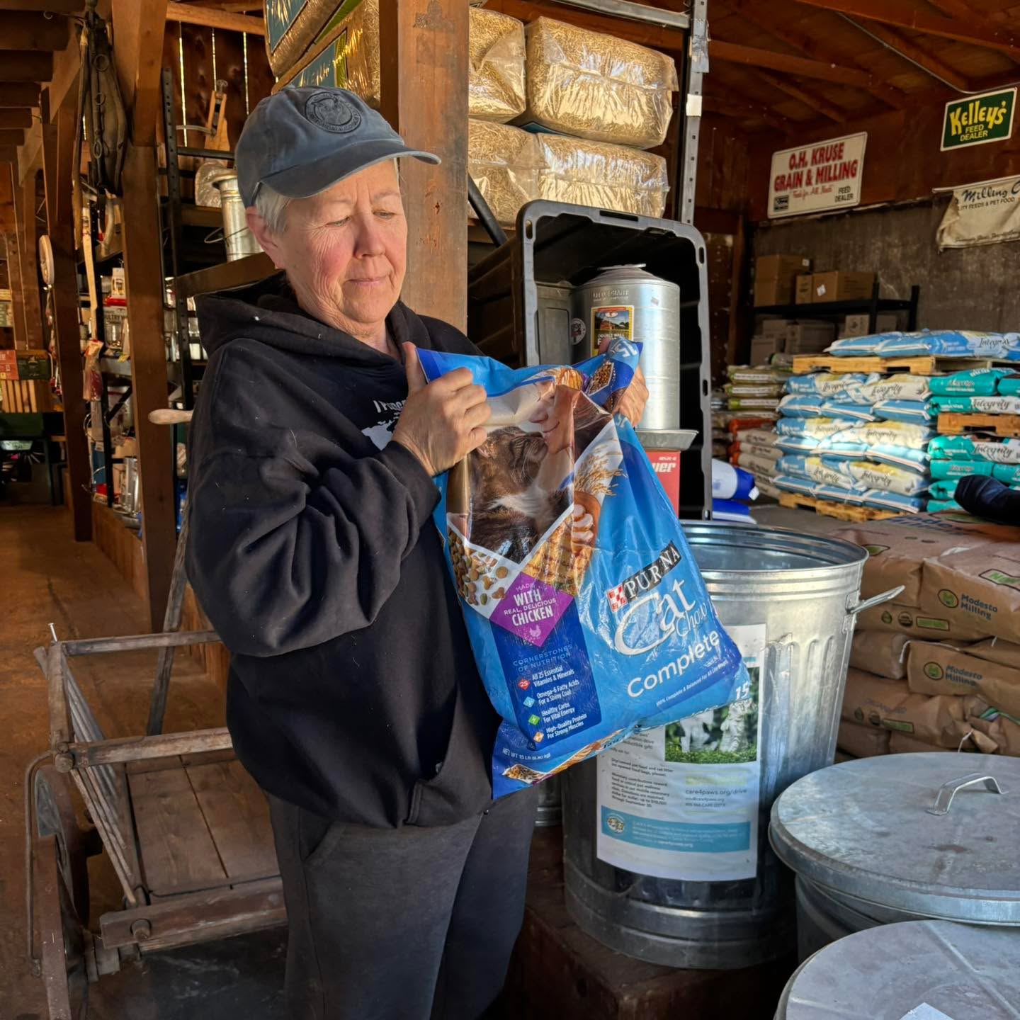 Dedicated community partner accepting a large bag of dog food as a donation