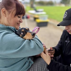 Dog held securely receiving a nail trim