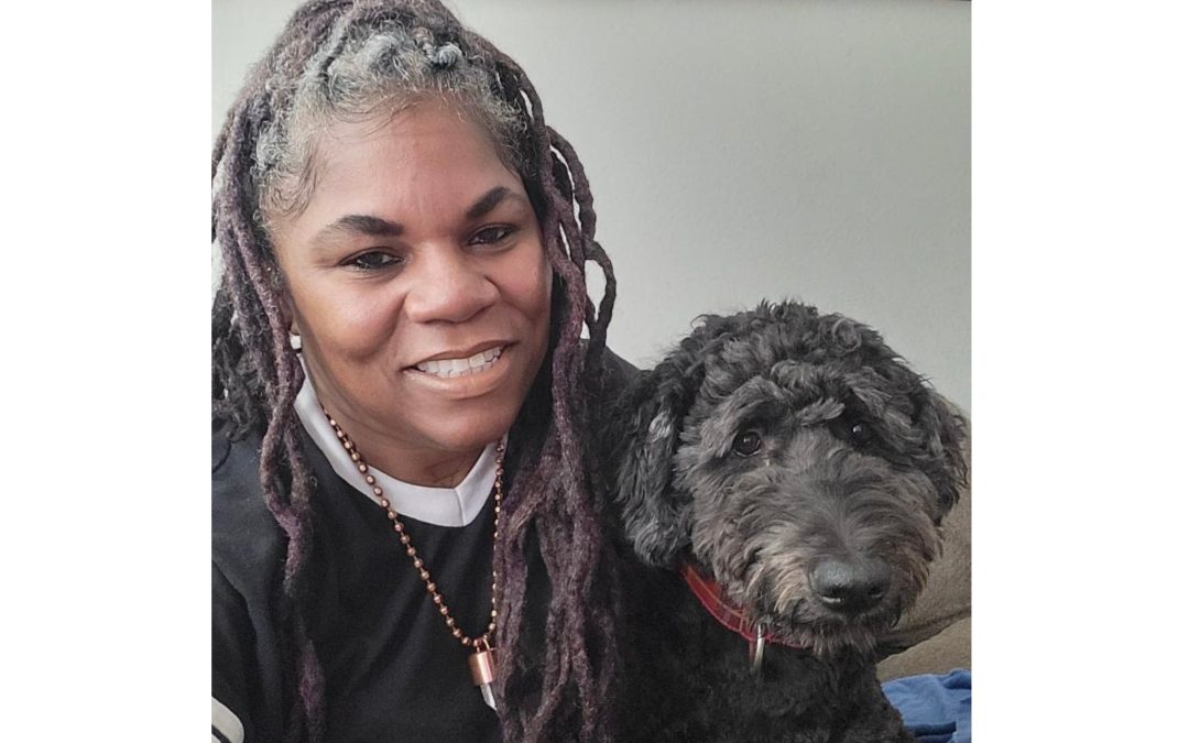 A lady smiling with her dog
