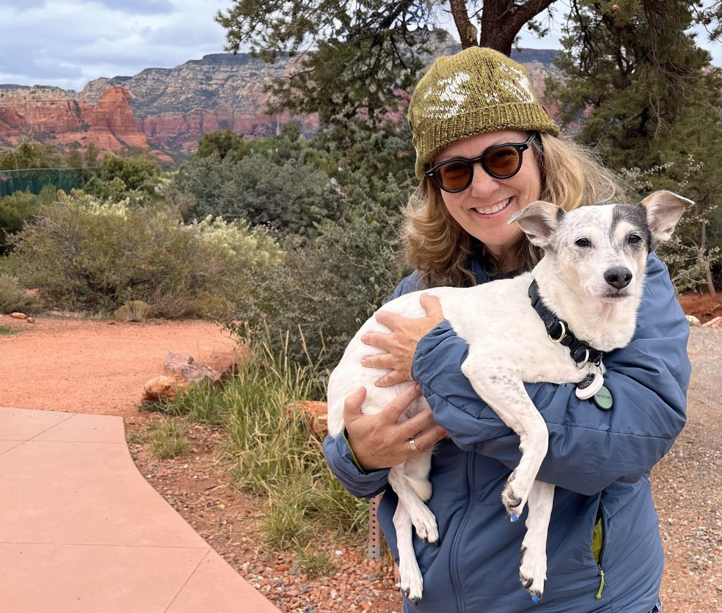 C.A.R.E.4Paws Board Member Laura Zeitz holding her small white dog