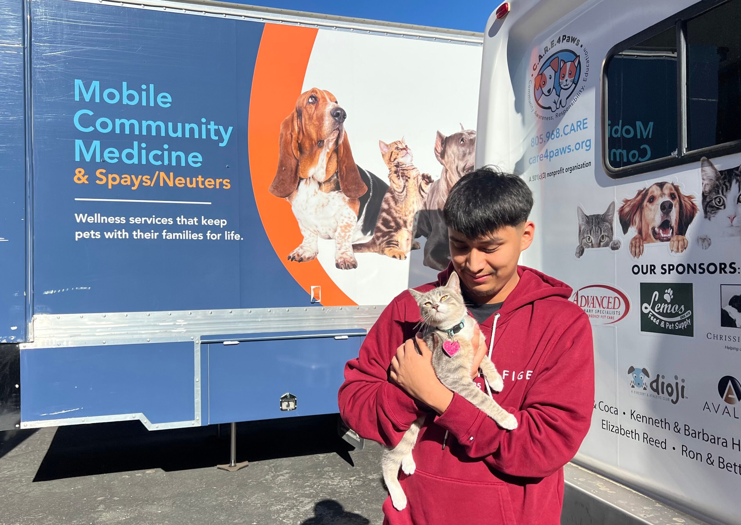 A client with his cat at C.A.R.E.4Paws mobile pet wellness clinic