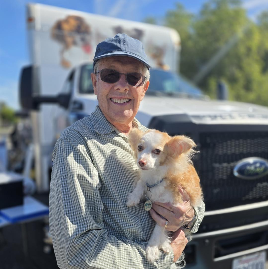 Senior client with his dog at a pet wellness clinic in Santa Barbara